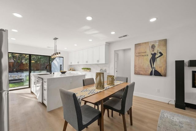 dining room featuring light hardwood / wood-style floors and sink