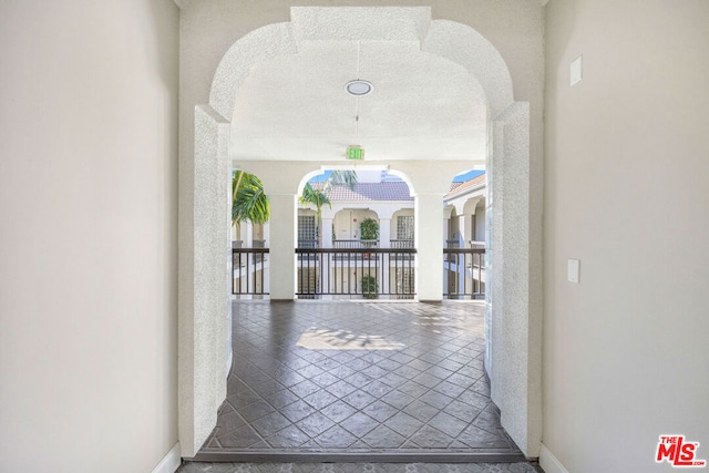 corridor featuring a textured ceiling