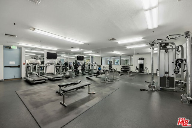 gym featuring a textured ceiling