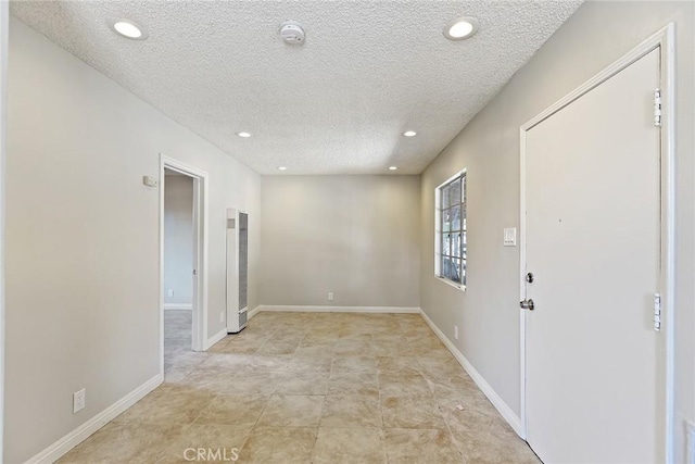 empty room with a textured ceiling