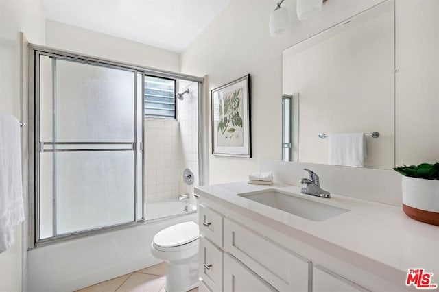 full bathroom with vanity, tile patterned floors, toilet, and combined bath / shower with glass door