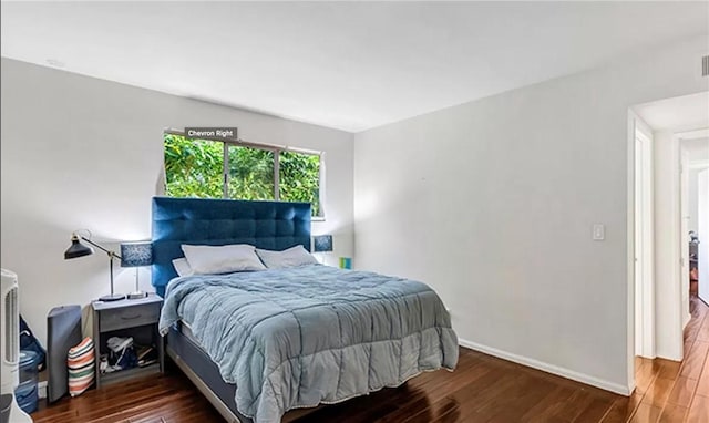 bedroom with dark wood-type flooring