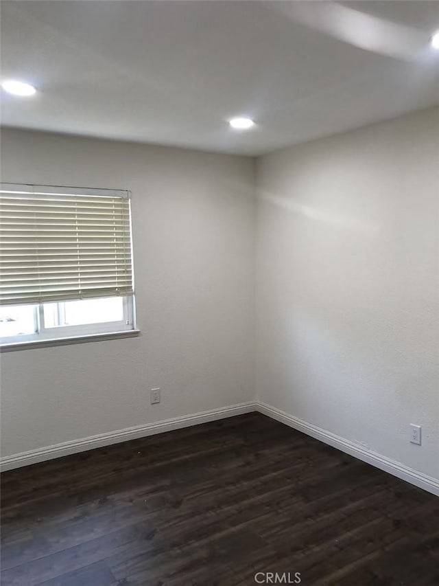 unfurnished room featuring dark hardwood / wood-style floors