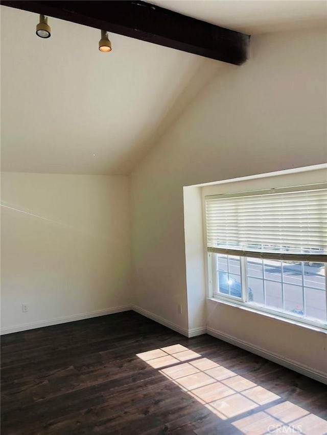 additional living space with hardwood / wood-style floors and vaulted ceiling with beams