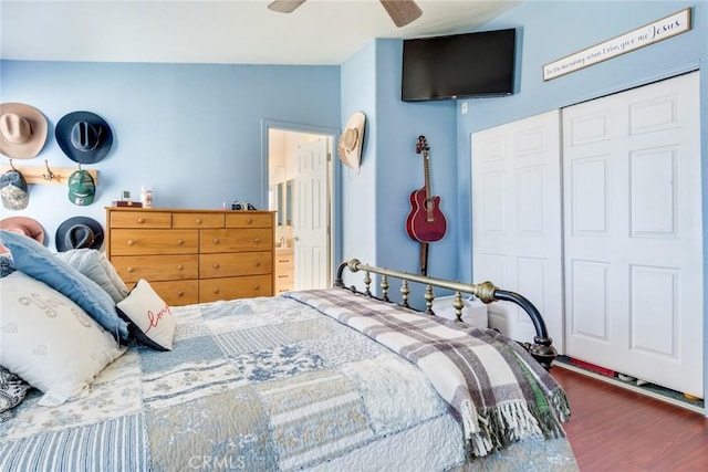 bedroom featuring vaulted ceiling, dark hardwood / wood-style floors, ceiling fan, and a closet