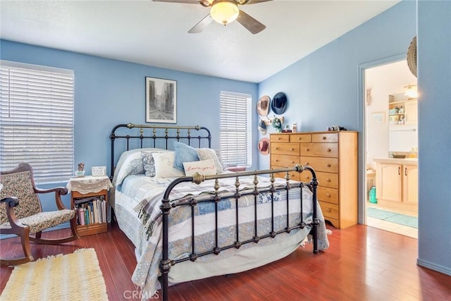 bedroom featuring hardwood / wood-style flooring, connected bathroom, and ceiling fan