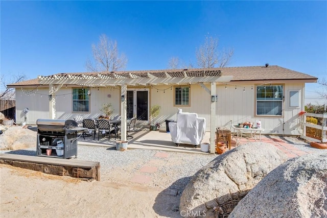 rear view of house featuring a pergola and a patio area