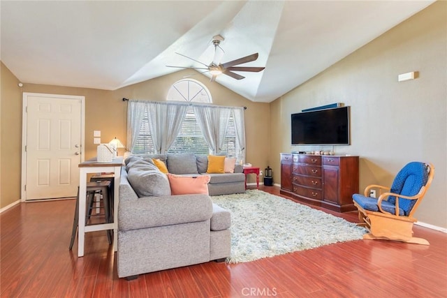 living room with hardwood / wood-style flooring, vaulted ceiling, and ceiling fan