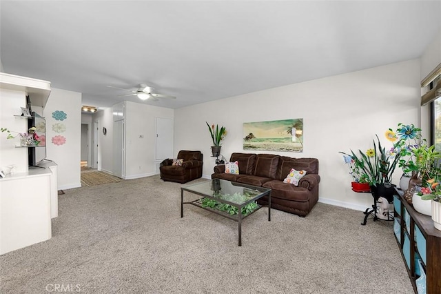 carpeted living room with ceiling fan