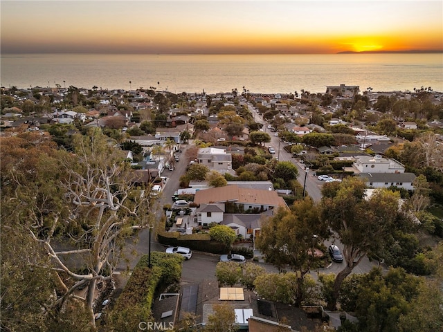 aerial view at dusk with a water view