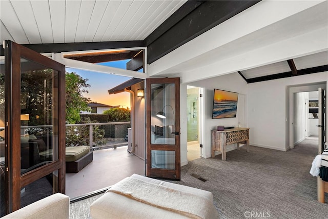 interior space featuring carpet flooring, lofted ceiling with beams, and ensuite bathroom