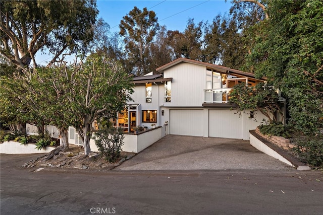 view of front of property with a garage and a balcony