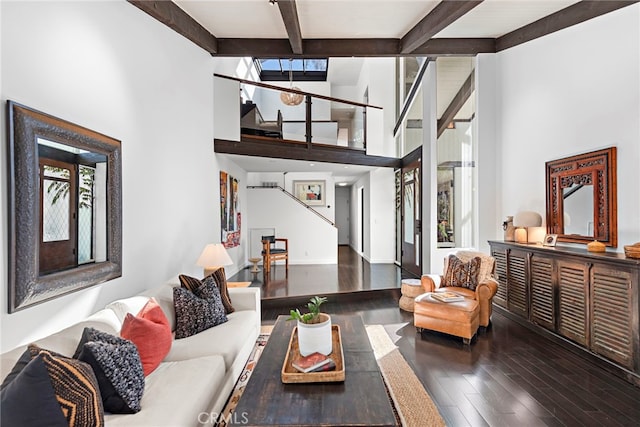 living room with dark hardwood / wood-style floors and beam ceiling