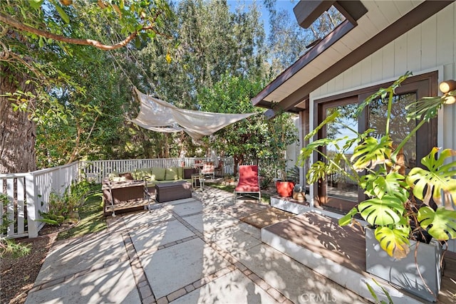 view of patio featuring an outdoor living space and a deck