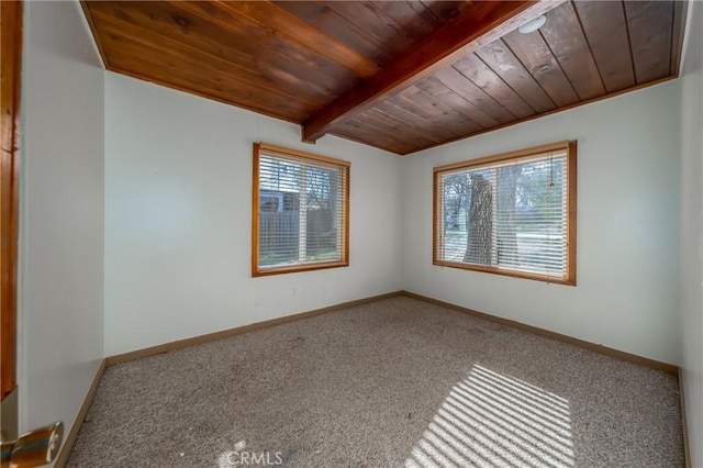 carpeted empty room featuring wood ceiling, plenty of natural light, and baseboards