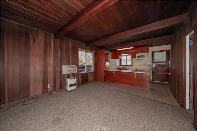 kitchen featuring a peninsula, white appliances, wood walls, beam ceiling, and heating unit