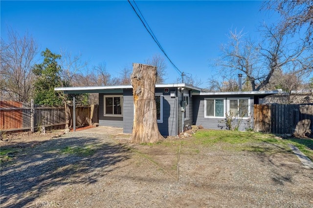 rear view of house featuring fence