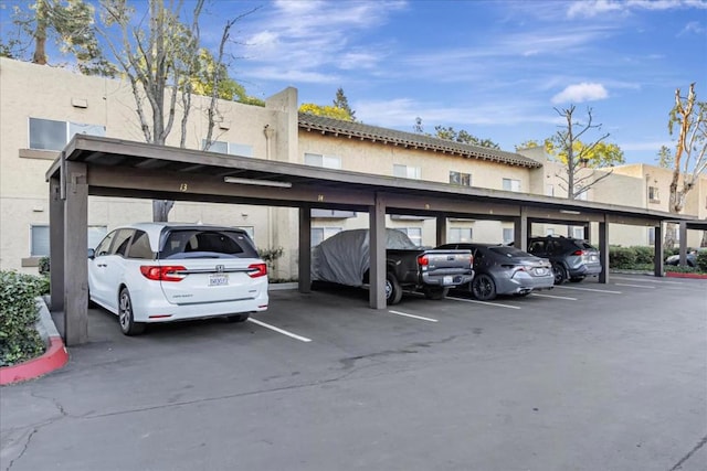 view of vehicle parking with a carport