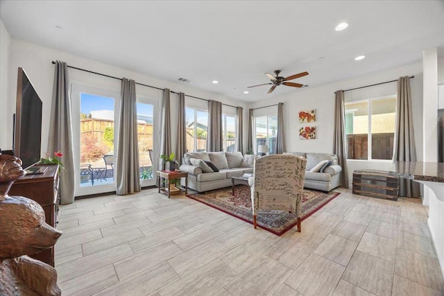 living room featuring a wealth of natural light and ceiling fan