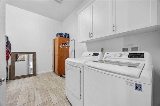 laundry room with washer and dryer and cabinets