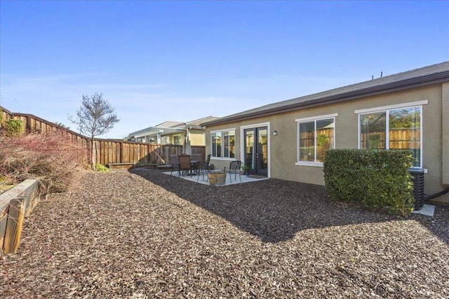 rear view of property with central AC and a patio