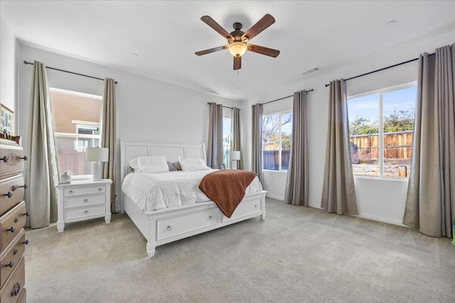 bedroom featuring light colored carpet and ceiling fan