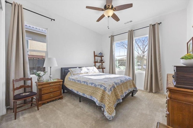 bedroom featuring light colored carpet and ceiling fan