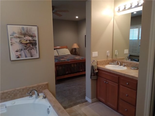 bathroom featuring tile patterned flooring, vanity, a washtub, and ceiling fan