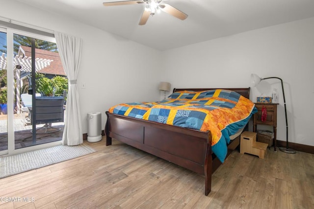 bedroom with access to outside, light hardwood / wood-style floors, and ceiling fan