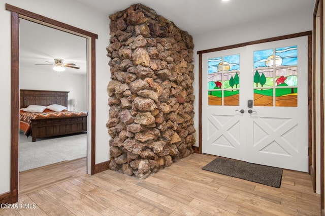 doorway to outside featuring light hardwood / wood-style floors and ceiling fan