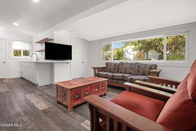 living room featuring dark hardwood / wood-style flooring, sink, and vaulted ceiling with beams