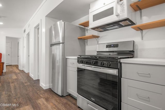 kitchen featuring dark hardwood / wood-style flooring, crown molding, and appliances with stainless steel finishes