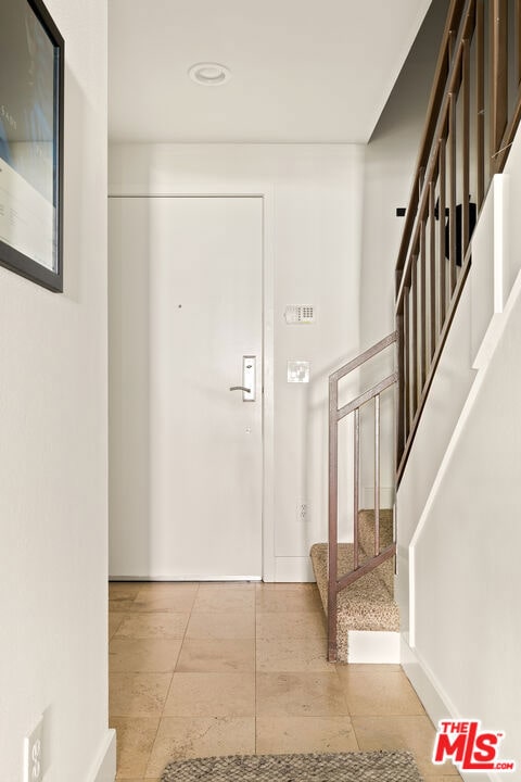 foyer entrance with light tile patterned flooring