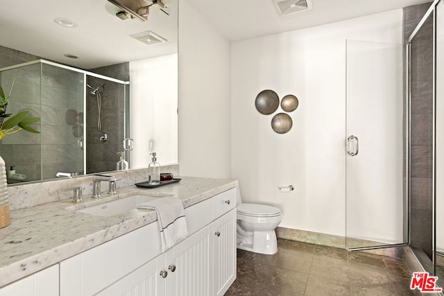 bathroom with vanity, toilet, and walk in shower