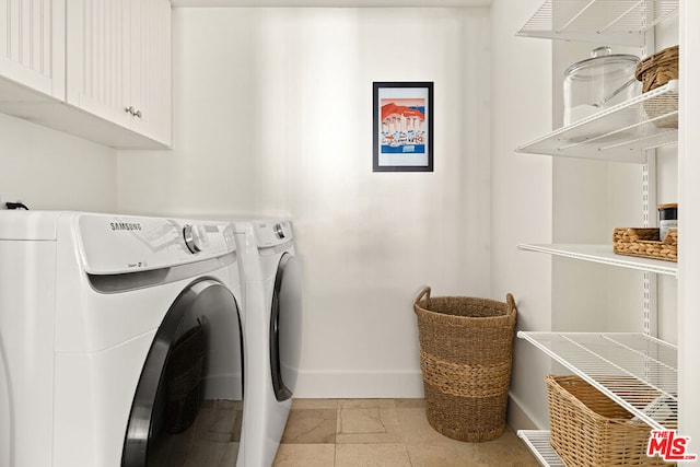 washroom with cabinets and washing machine and clothes dryer