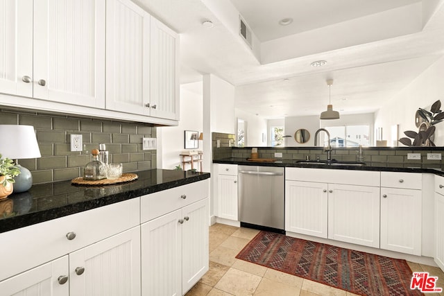 kitchen featuring sink, stainless steel dishwasher, white cabinets, and decorative backsplash