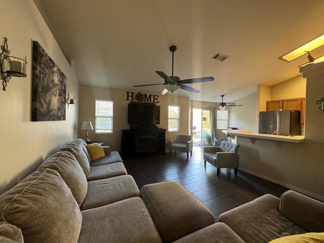 living room with lofted ceiling and a fireplace