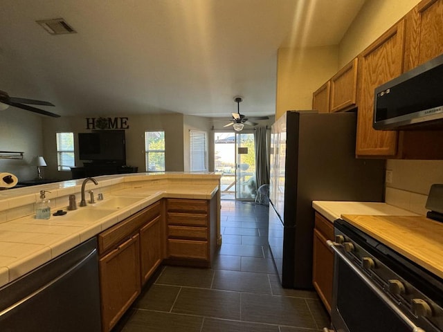 kitchen featuring ceiling fan, range, dishwasher, and sink