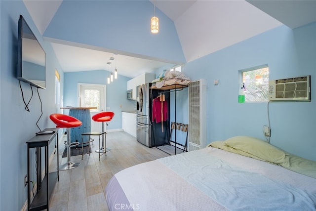 bedroom with stainless steel fridge with ice dispenser, light hardwood / wood-style floors, vaulted ceiling, and an AC wall unit