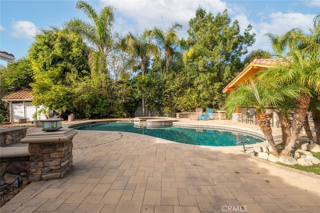 view of pool with a patio and an in ground hot tub