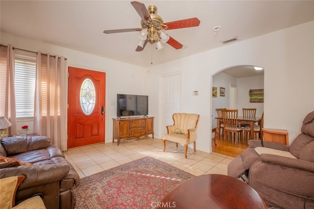 tiled living room featuring ceiling fan