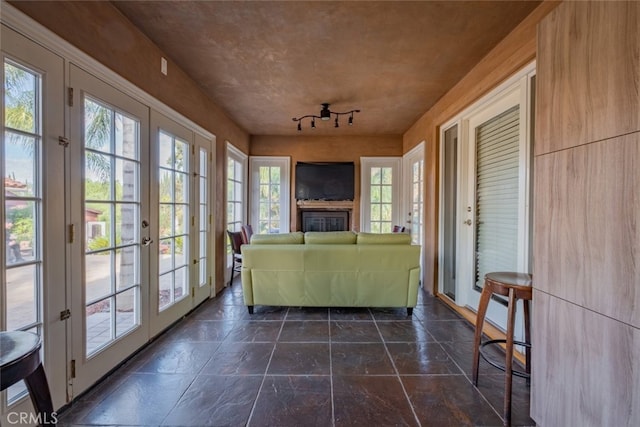 unfurnished sunroom featuring plenty of natural light and french doors