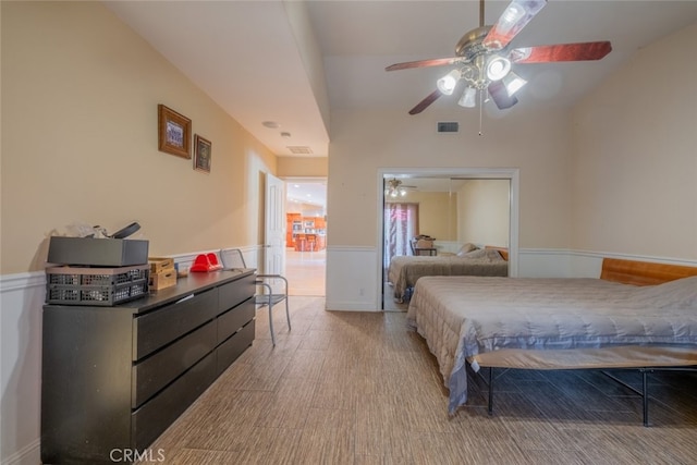 bedroom with hardwood / wood-style flooring, ceiling fan, and a closet