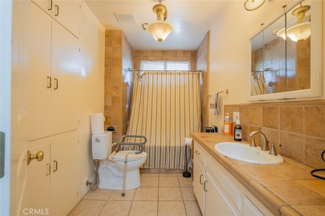 bathroom featuring tasteful backsplash, tile patterned floors, toilet, and vanity