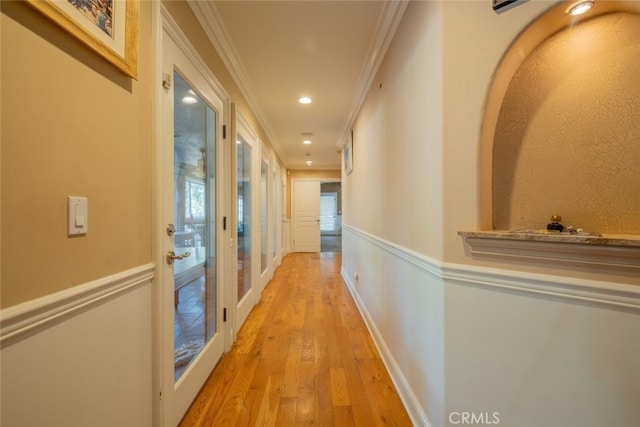 hall with ornamental molding and light wood-type flooring