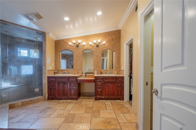 bathroom with crown molding, vanity, and a shower with door