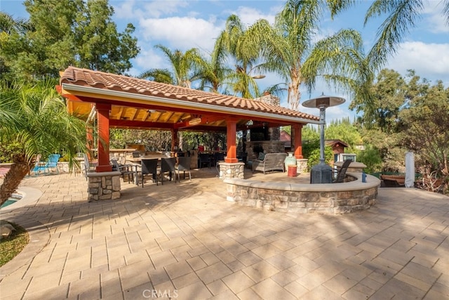 view of patio / terrace featuring a gazebo and exterior bar