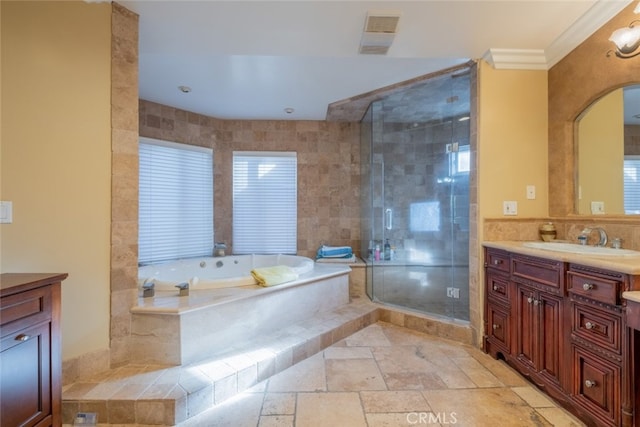 bathroom featuring ornamental molding, vanity, and separate shower and tub