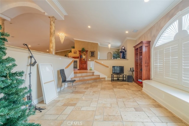 foyer entrance with vaulted ceiling, ornamental molding, and ornate columns