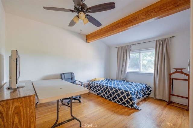 bedroom with ceiling fan, beamed ceiling, and light wood-type flooring